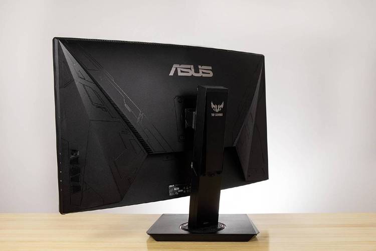 Gamer playing FPS on large curved monitor