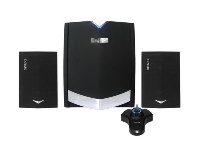 Person listening to small speakers on laptop