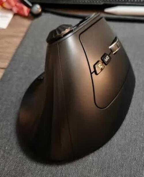 Ergonomic mouse in use on black background