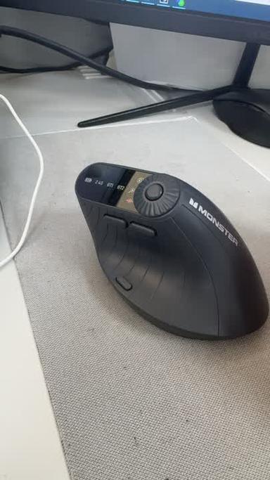 Cordless mouse beside power bank charging