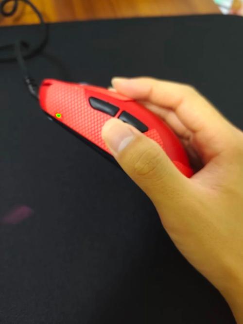 Modern black ergonomic computer mouse in use