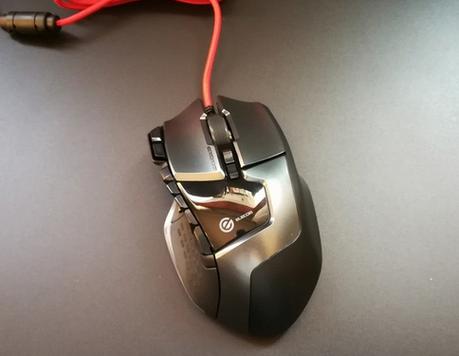 Black computer mouse with cord on desk