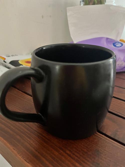 Person using black wired mouse at desk