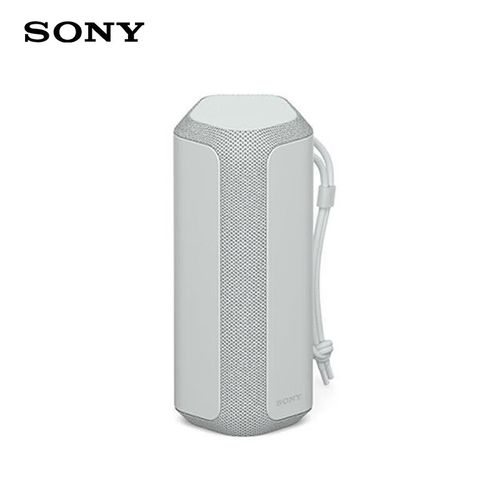 Person using portable speaker at beach or outdoor