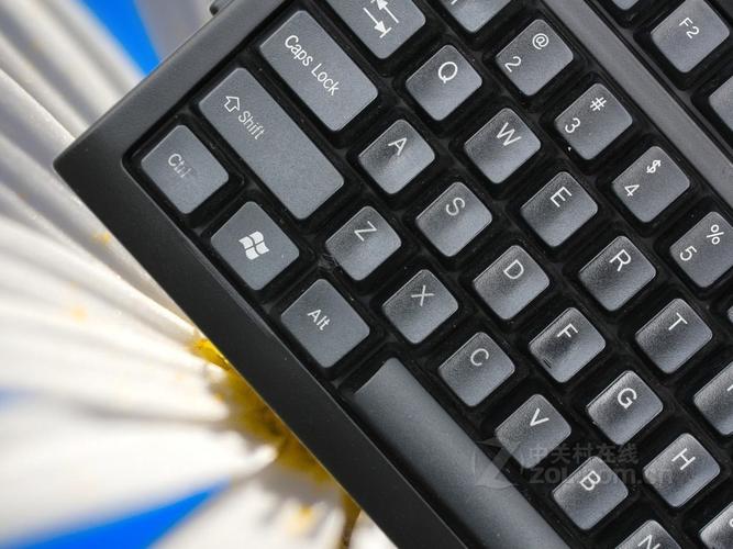 Computer keyboard with orange cable close-up