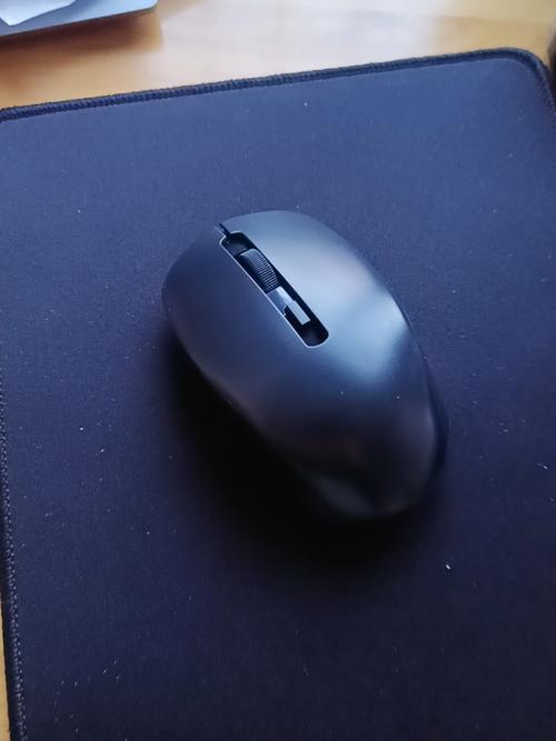 Compact black computer mouse on desk