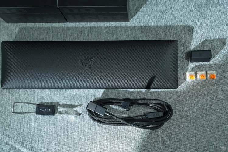 Close-up of hands typing on a keyboard with RGB lighting