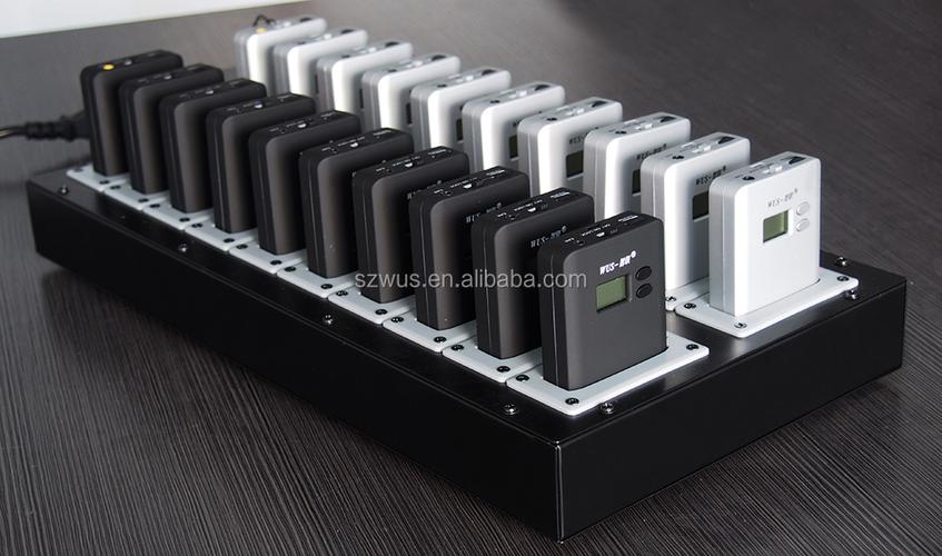 Person choosing between different electronic devices on a desk