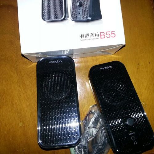 Desktop speaker playing music in office environment