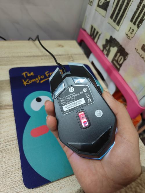 Black mouse connected to laptop in workspace