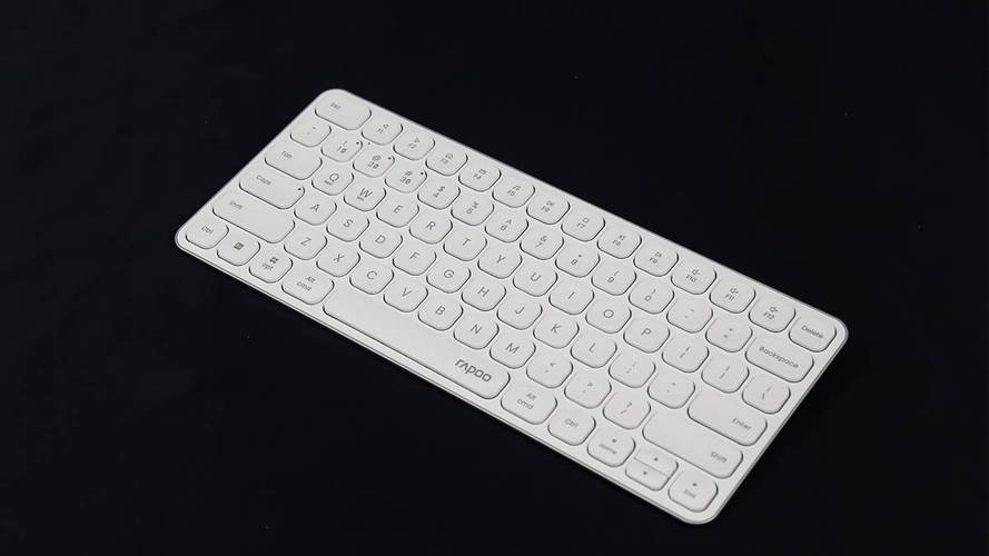 Modern desk setup with wireless keyboard and battery focus