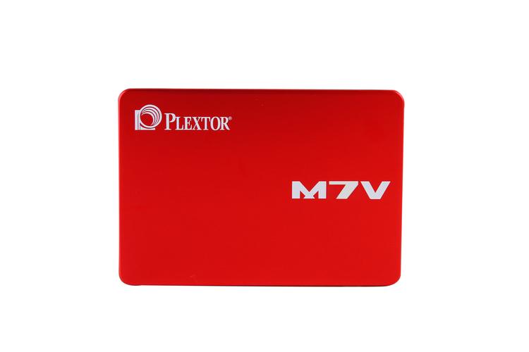 Person holding SSD in front of laptop for performance demo
