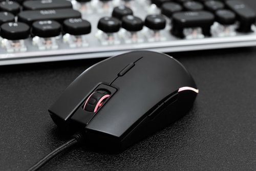 Gaming mouse on desk with RGB lighting